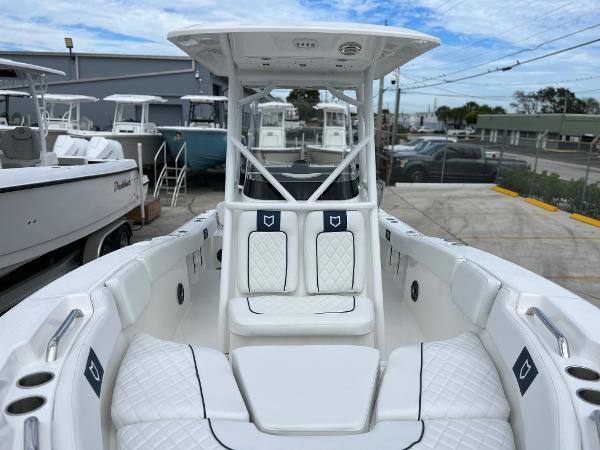 Slide: The Image of 2024 Sea Fox 228 Commander boat interior with white seating and T-top. - 15