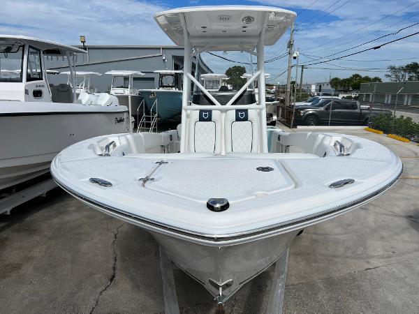 Slide: The Image of 2024 Sea Fox 228 Commander boat displayed in a marina. - 2