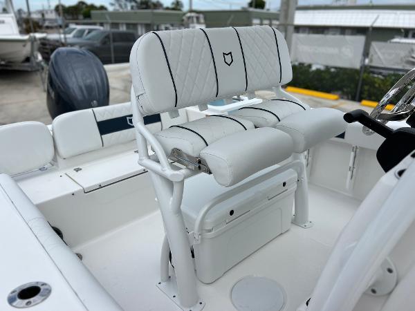 Slide: The Image of 2024 Sea Fox 228 Commander boat with white cushioned seating and storage. - 28