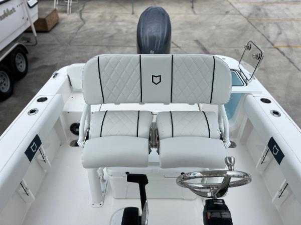 Slide: The Image of 2024 Sea Fox 228 Commander boat interior with dual white cushioned seats and steering wheel. - 29