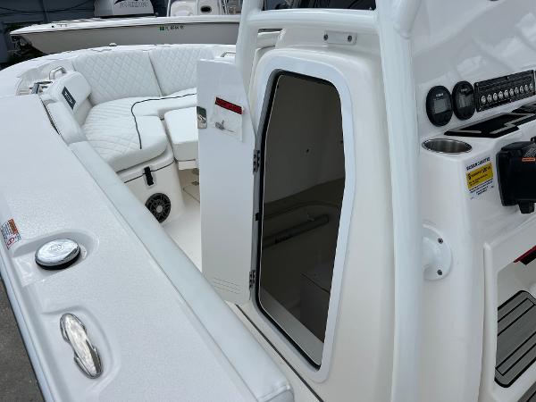 Slide: The Image of 2024 Sea Fox 228 Commander boat interior with open cabin door and seating area. - 34