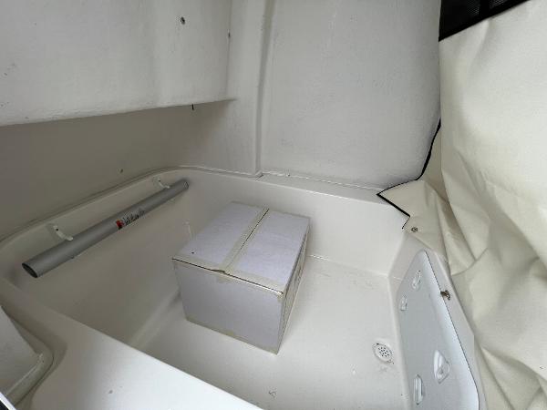 Slide: The Image of 2024 Sea Fox 228 Commander storage compartment with a white box. - 36
