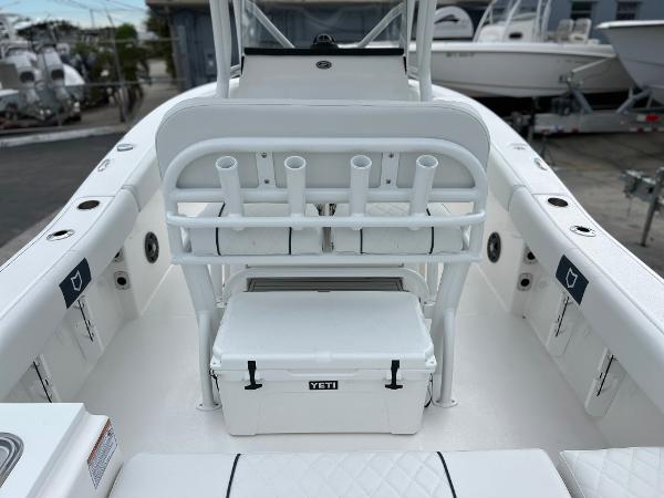 Slide: The Image of 2024 Sea Fox 228 Commander boat interior with rod holders and Yeti cooler. - 37
