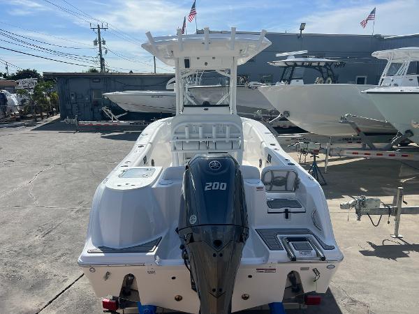 Slide: The Image of 2024 Sea Fox 228 Commander boat with Yamaha 200 outboard motor in a marina. - 49