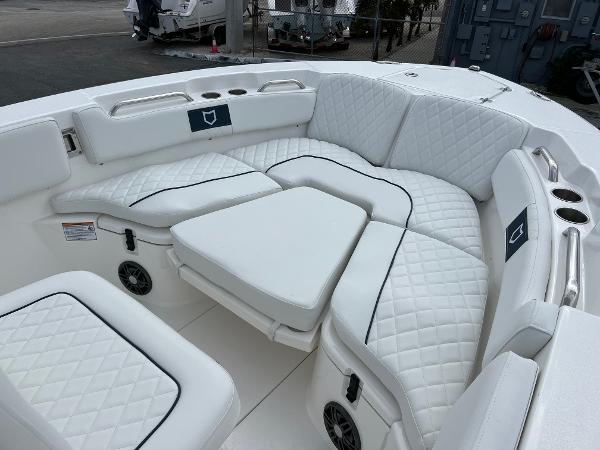 Slide: The Image of 2024 Sea Fox 228 Commander boat with white cushioned seating area. - 8