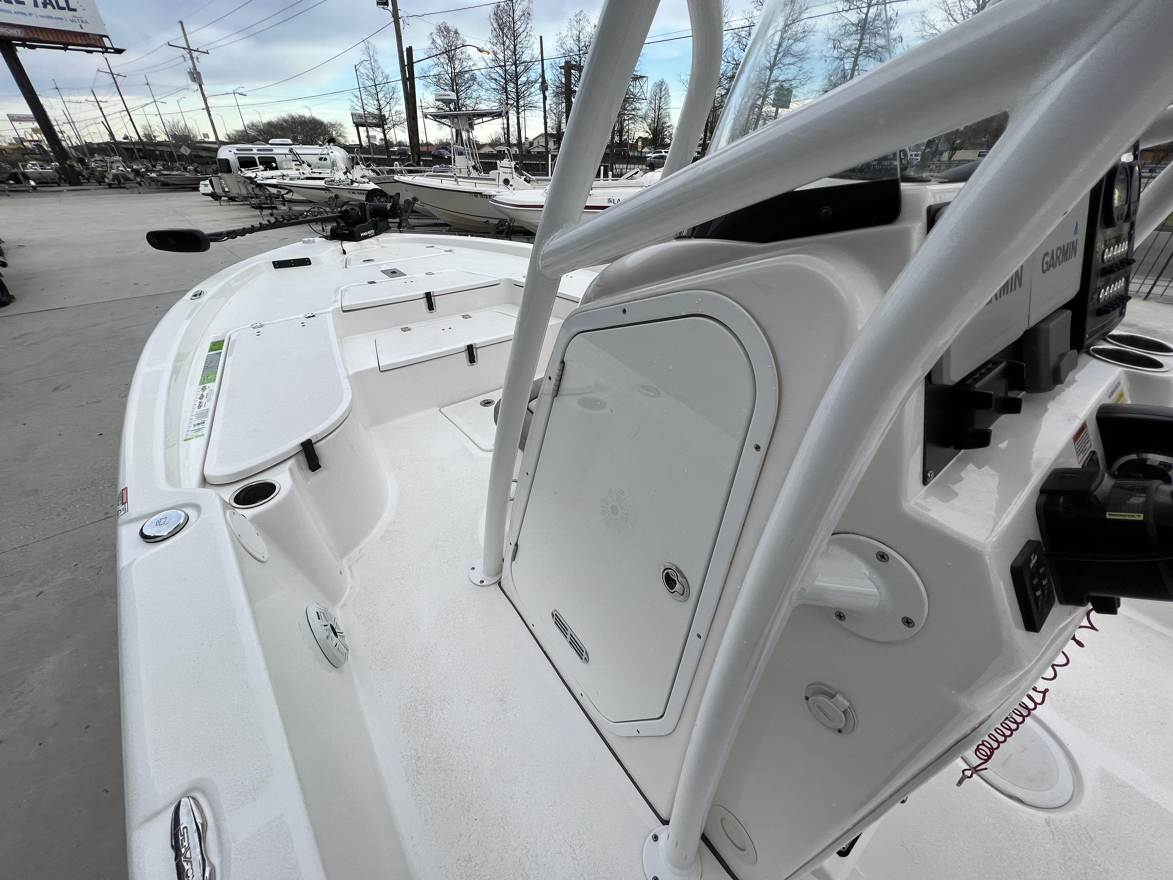 Slide: The Image of 2020 Sea Fox 240 Viper boat deck with console and equipment in marina setting. - 15