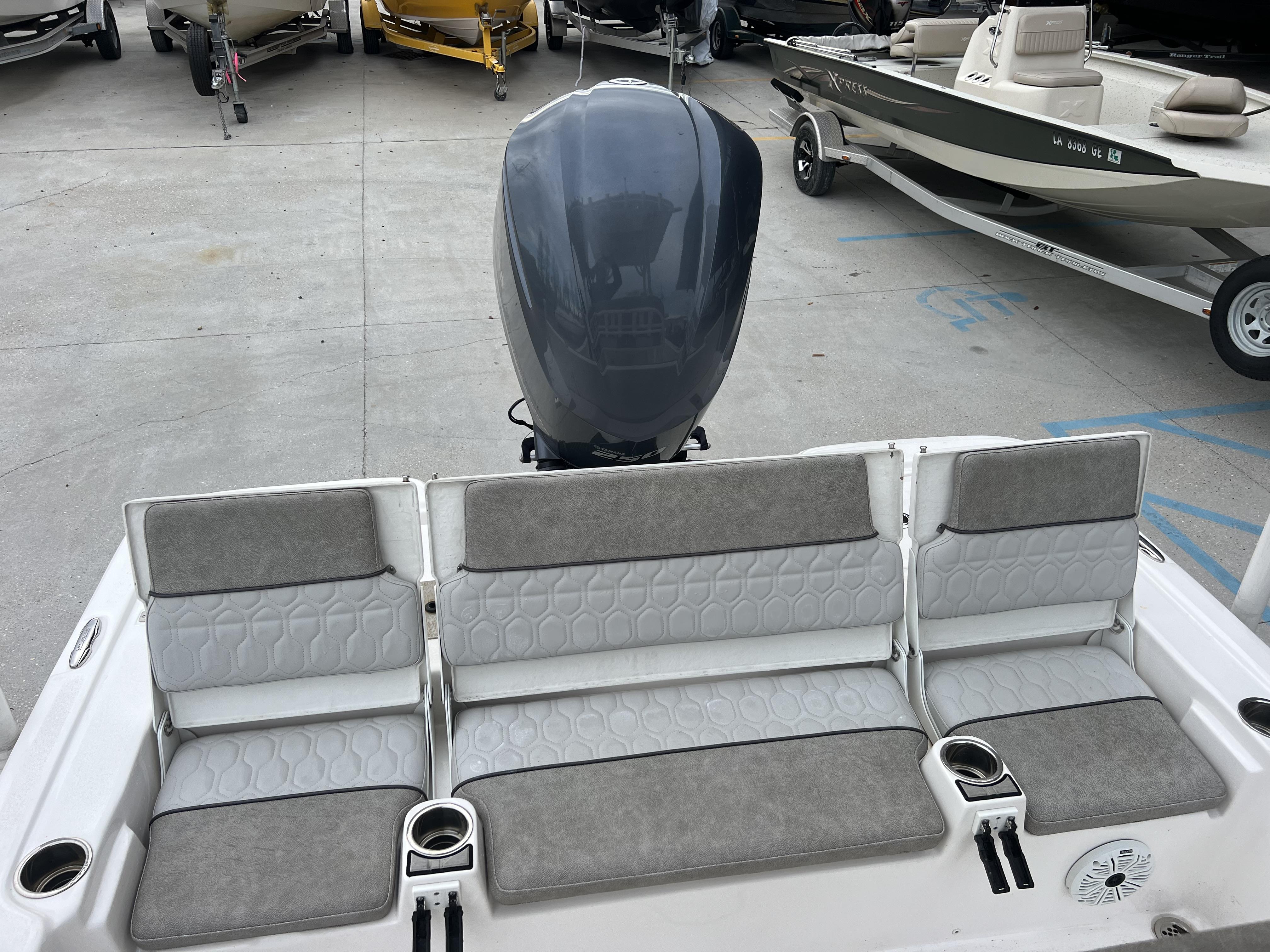 Slide: The Image of 2020 Sea Fox 240 Viper boat with cushioned seating and outboard motor. - 2