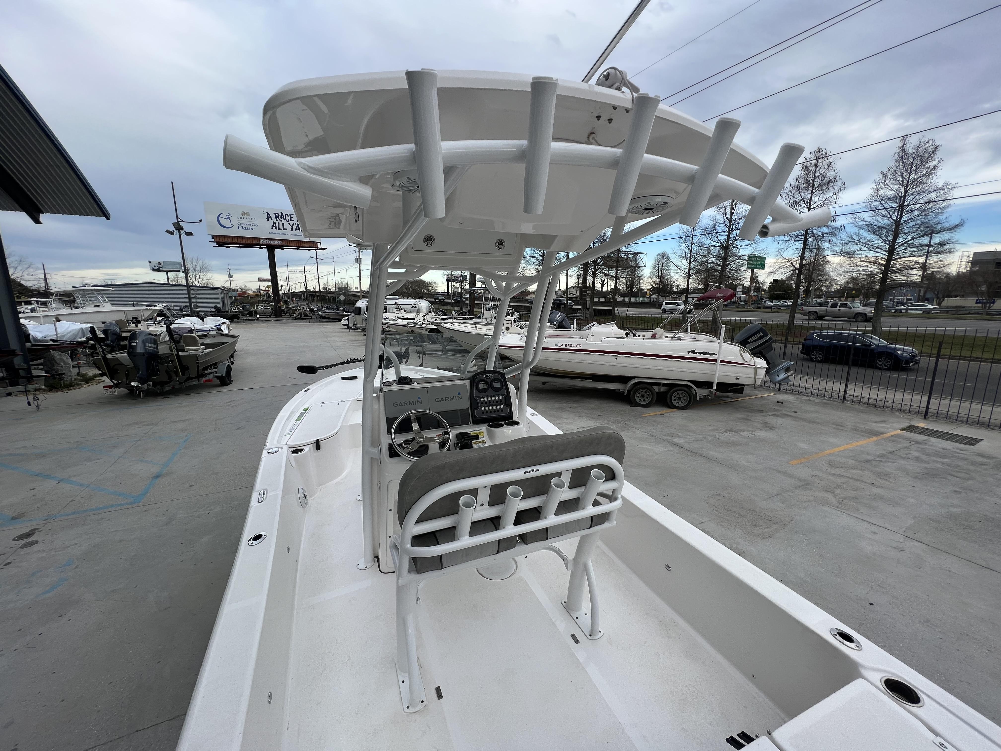 Slide: The Image of 2020 Sea Fox 240 Viper boat in a marina, showcasing helm and seating area. - 7