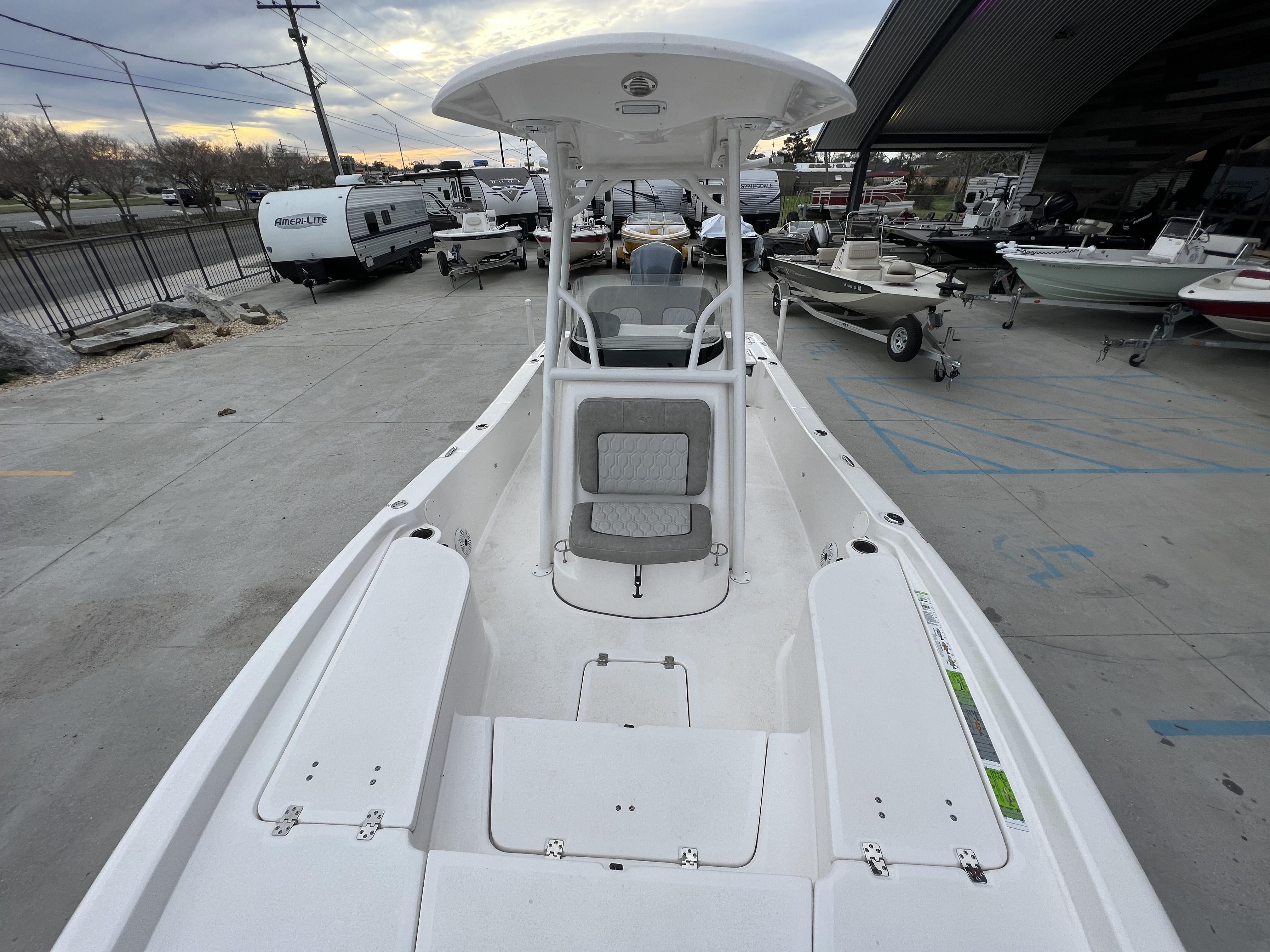 Slide: The Image of 2020 Sea Fox 240 Viper boat in a marina, surrounded by other boats and trailers. - 9