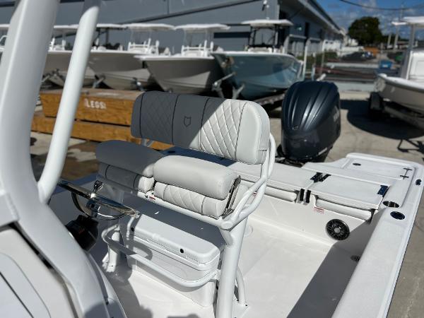 Slide: The Image of 2024 Sea Fox 251 Bay Fox boat interior with cushioned seating and outboard motor. - 15