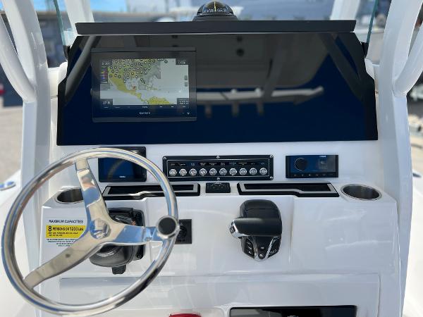 Slide: The Image of 2024 Sea Fox 251 Bay Fox boat dashboard with navigation screen and steering wheel. - 20