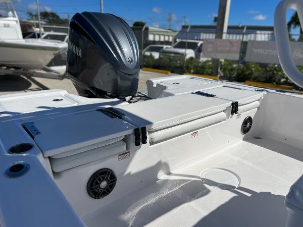 Slide: The Image of 2024 Sea Fox 251 Bay Fox boat with Yamaha engine, rear seating, and storage compartments. - 24