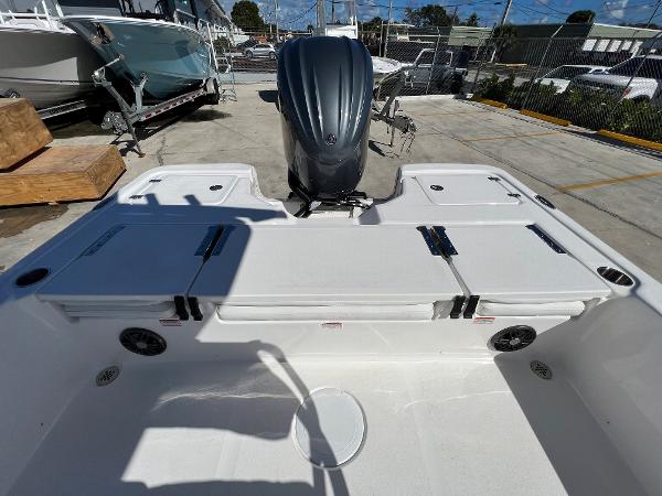 Slide: The Image of 2024 Sea Fox 251 Bay Fox boat stern with outboard motor and storage compartments. - 25