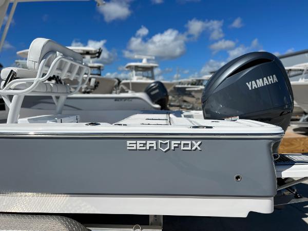 Slide: The Image of 2024 Sea Fox 251 Bay Fox boat with Yamaha engine, docked under a clear blue sky. - 36