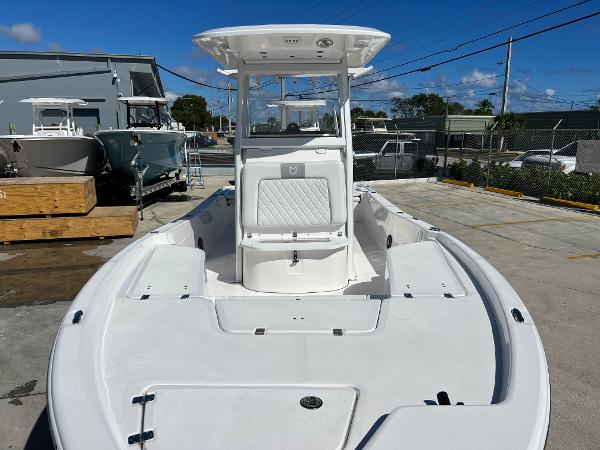 Slide: The Image of 2024 Sea Fox 251 Bay Fox boat, front deck view at a marina. - 8