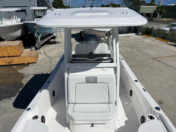Slide: The Image of 2024 Sea Fox 251 Bay Fox boat, white interior, center console, docked. - 9