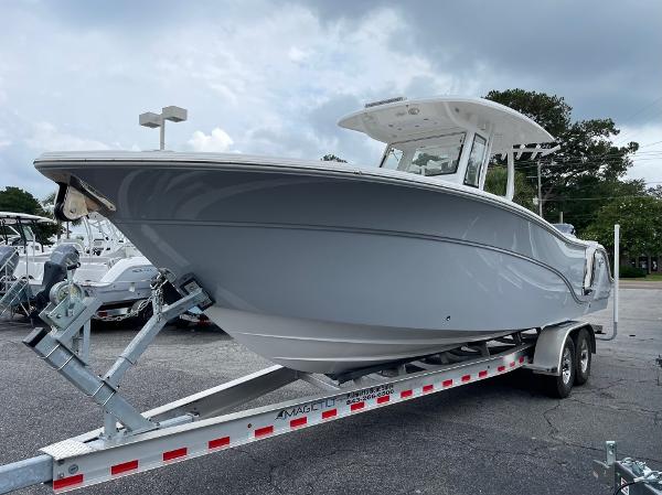 Slide: The Image of 2024 Sea Fox 288 Commander boat on trailer, parked outdoors under cloudy sky. - 1