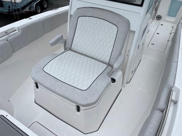 Slide: The Image of 2024 Sea Fox 288 Commander boat seat with cushioned armrests and storage. - 12