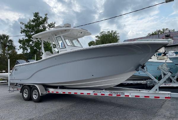 Slide: The Image of 2024 Sea Fox 288 Commander boat on a trailer, parked outdoors. - 2