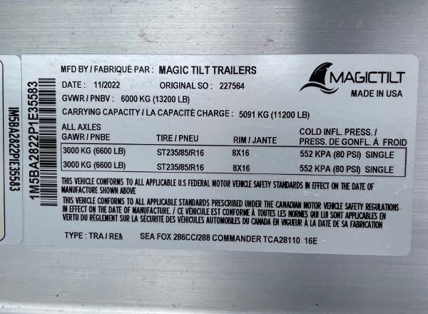 Slide: The Image of Magic Tilt Trailers label for 2024 Sea Fox 288 Commander, showing specifications and safety standards. - 24