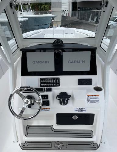 Slide: The Image of 2024 Sea Fox 288 Commander helm with dual Garmin displays and steering wheel. - 7