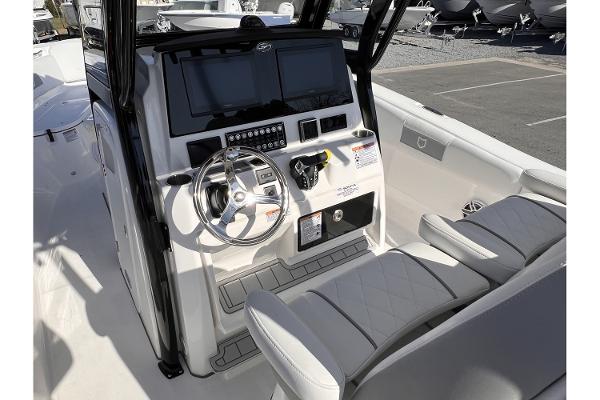 Slide: The Image of 2024 Sea Fox 288 Commander boat helm with dual screens and cushioned seating. - 11