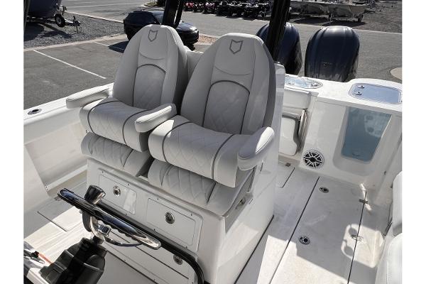Slide: The Image of 2024 Sea Fox 288 Commander boat with dual captain's chairs and modern helm. - 9