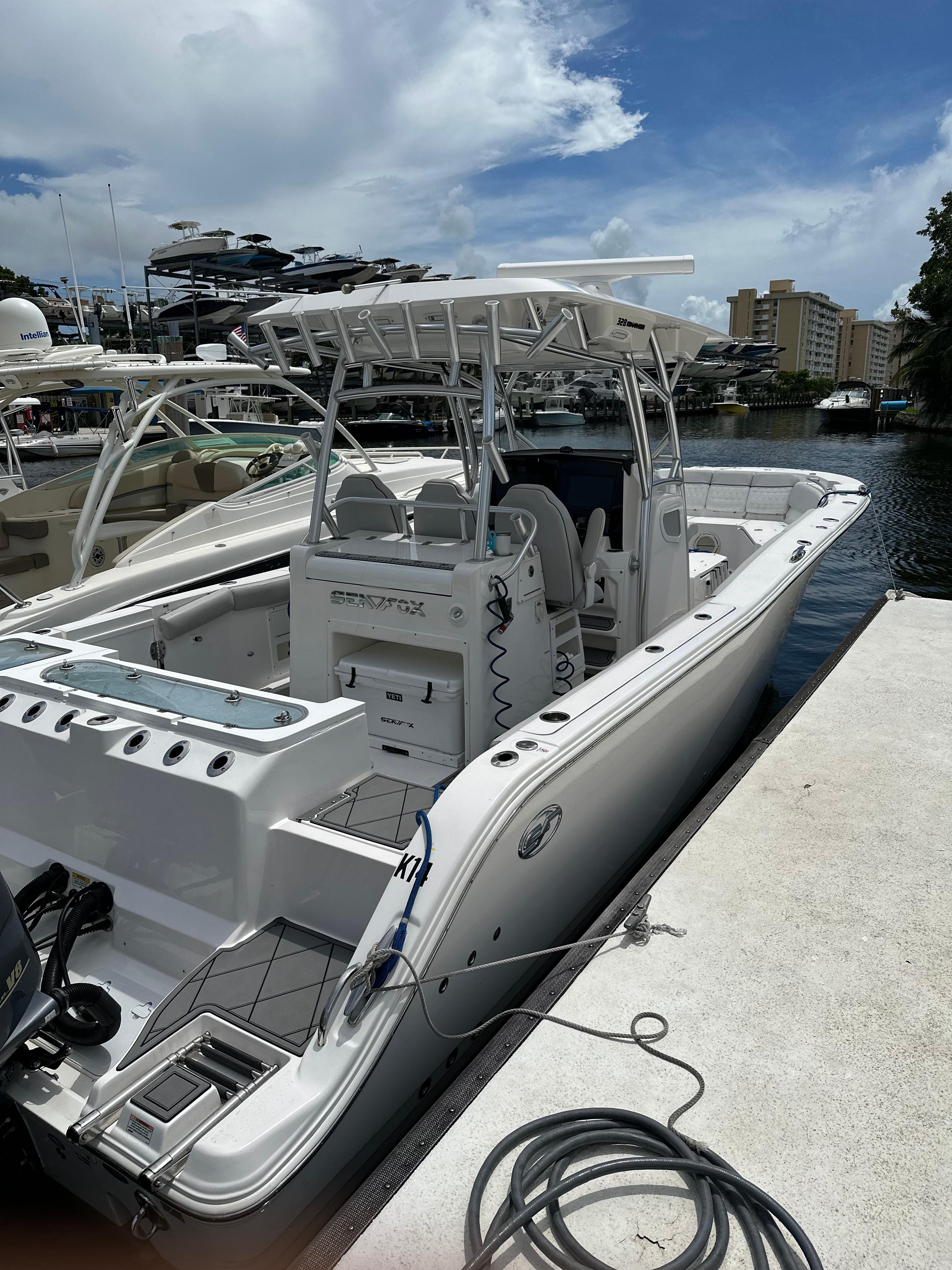 Slide: The Image of 2020 Sea Fox 328 Commander docked at marina under a partly cloudy sky. - 1