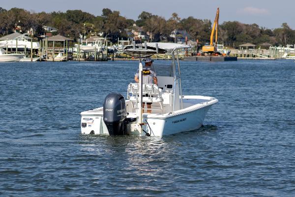 Slide: The Image of 2016 Sea Hunt BX 22 BR boat on calm water near docks. - 1