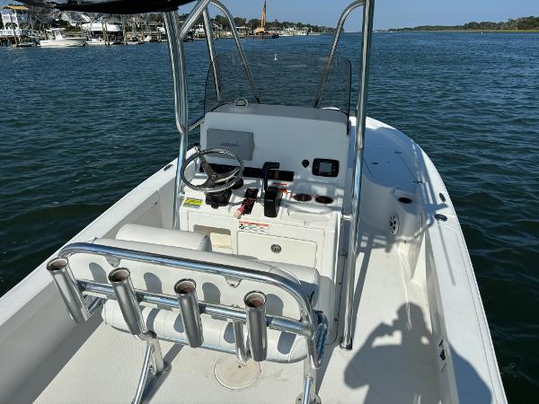 Slide: The Image of 2016 Sea Hunt BX 22 BR boat on calm water, featuring a sleek console and rod holders. - 10