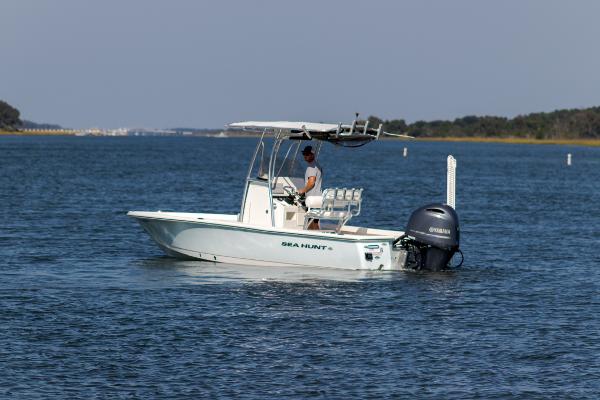 Slide: The Image of 2016 Sea Hunt BX 22 BR boat cruising on a calm lake. - 3