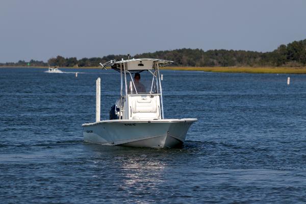 Slide: The Image of 2016 Sea Hunt BX 22 BR boat cruising on a calm lake. - 4