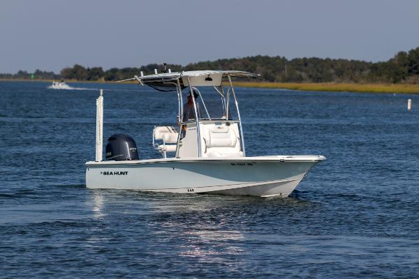 Slide: The Image of 2016 Sea Hunt BX 22 BR boat cruising on a calm lake. - 5