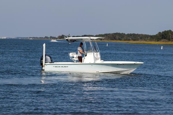 Slide: The Image of 2016 Sea Hunt BX 22 BR boat cruising on a calm lake. - 6