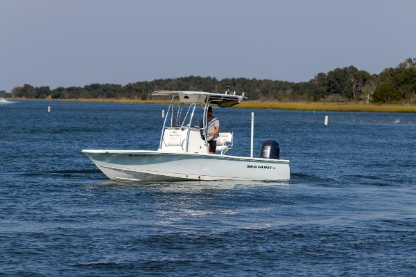 Slide: The Image of 2016 Sea Hunt BX 22 BR boat cruising on a calm lake. - 7