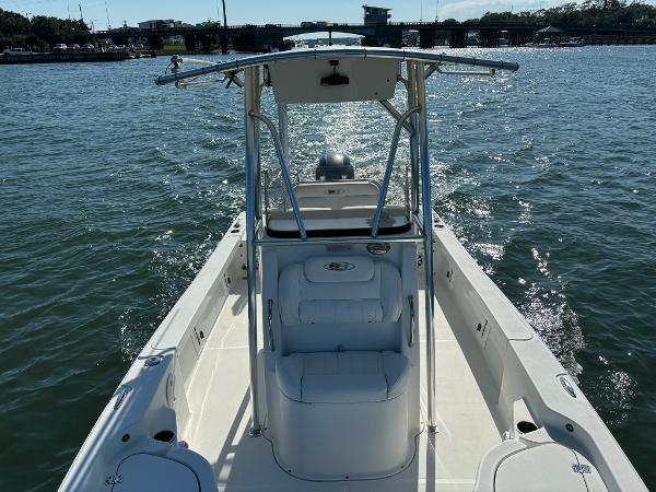 Slide: The Image of 2016 Sea Hunt BX 22 BR boat on water, featuring center console and T-top. - 8