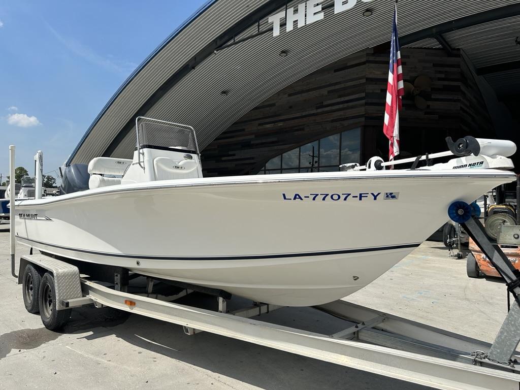 Slide: The Image of 2012 Sea Hunt BX 22 Pro boat on trailer, parked outside a building. - 1