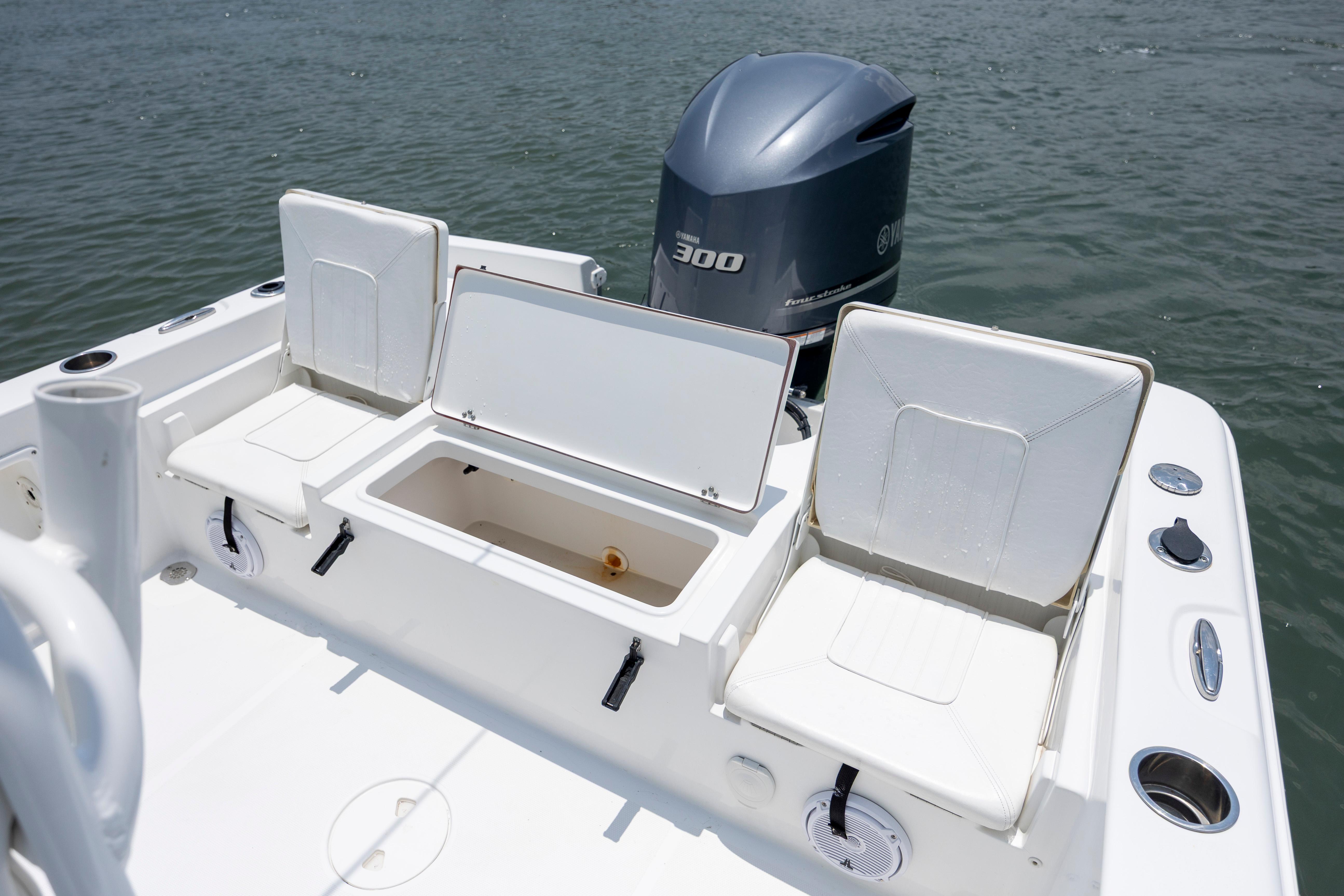 Slide: The Image of 2016 Sea Hunt BX 24 BR boat with Yamaha 300 engine, featuring open storage compartments. - 13