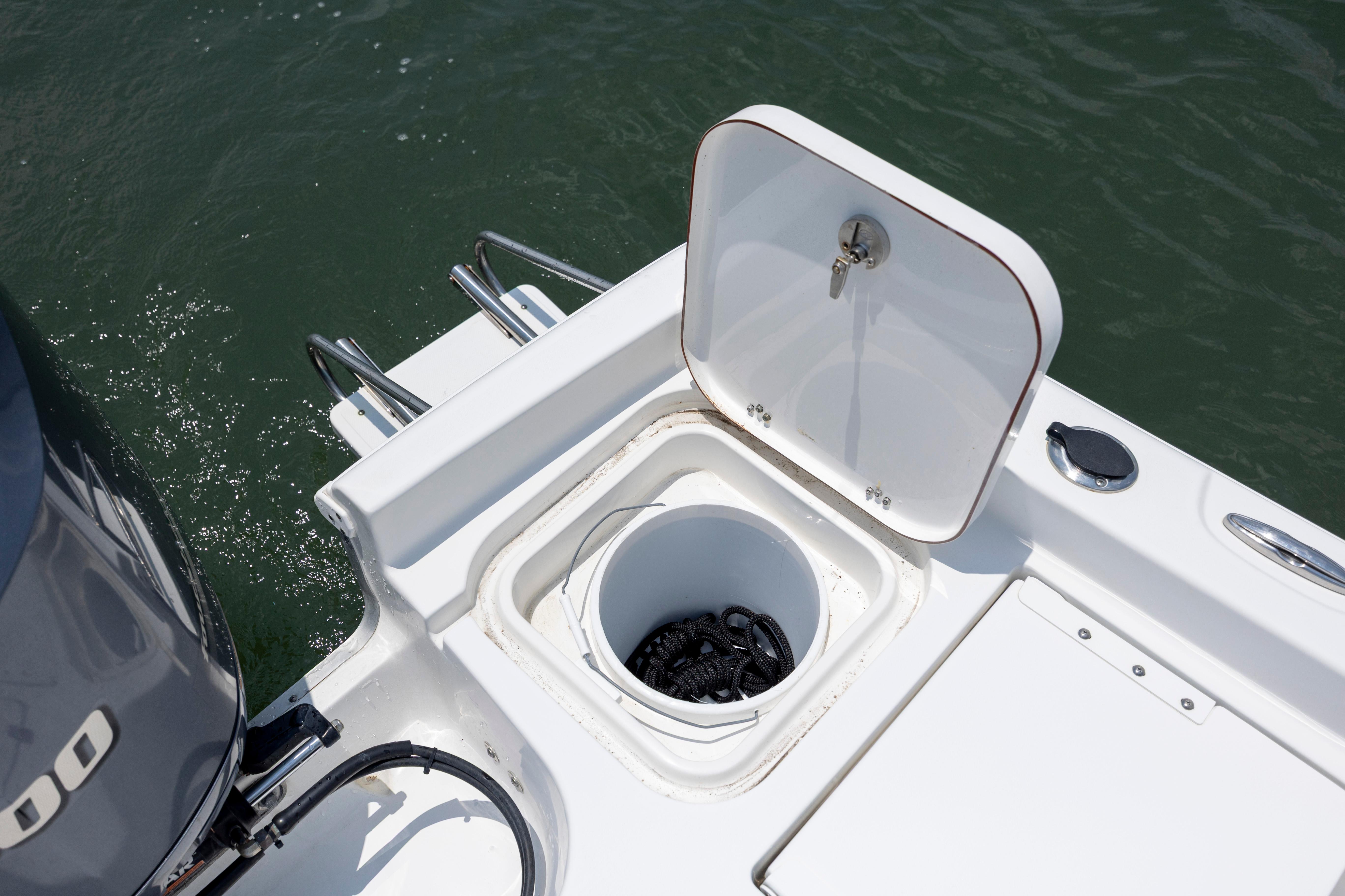 Slide: The Image of 2016 Sea Hunt BX 24 BR boat with open storage compartment on deck. - 14