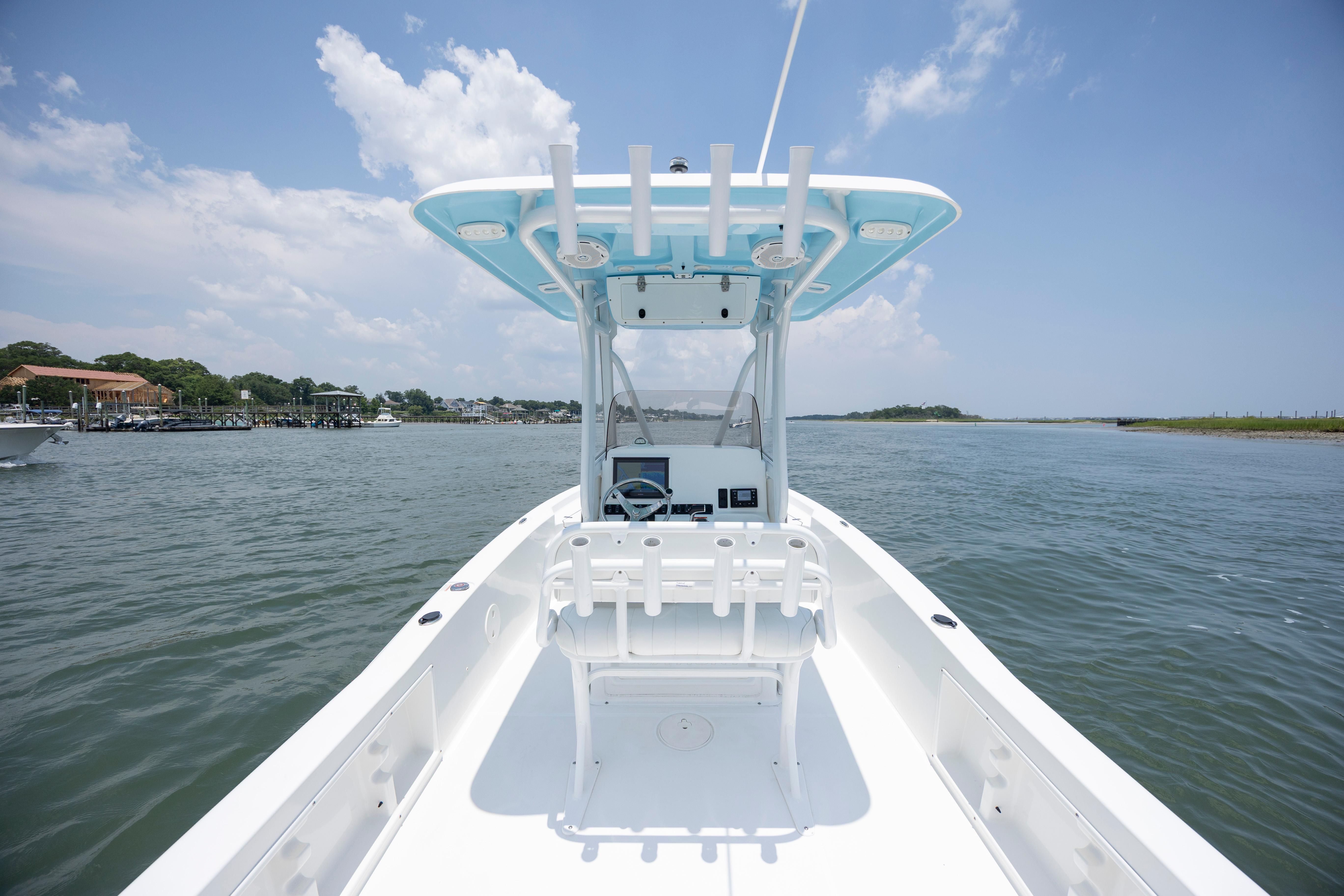 Slide: The Image of 2016 Sea Hunt BX 24 BR boat on calm water under a clear blue sky. - 16