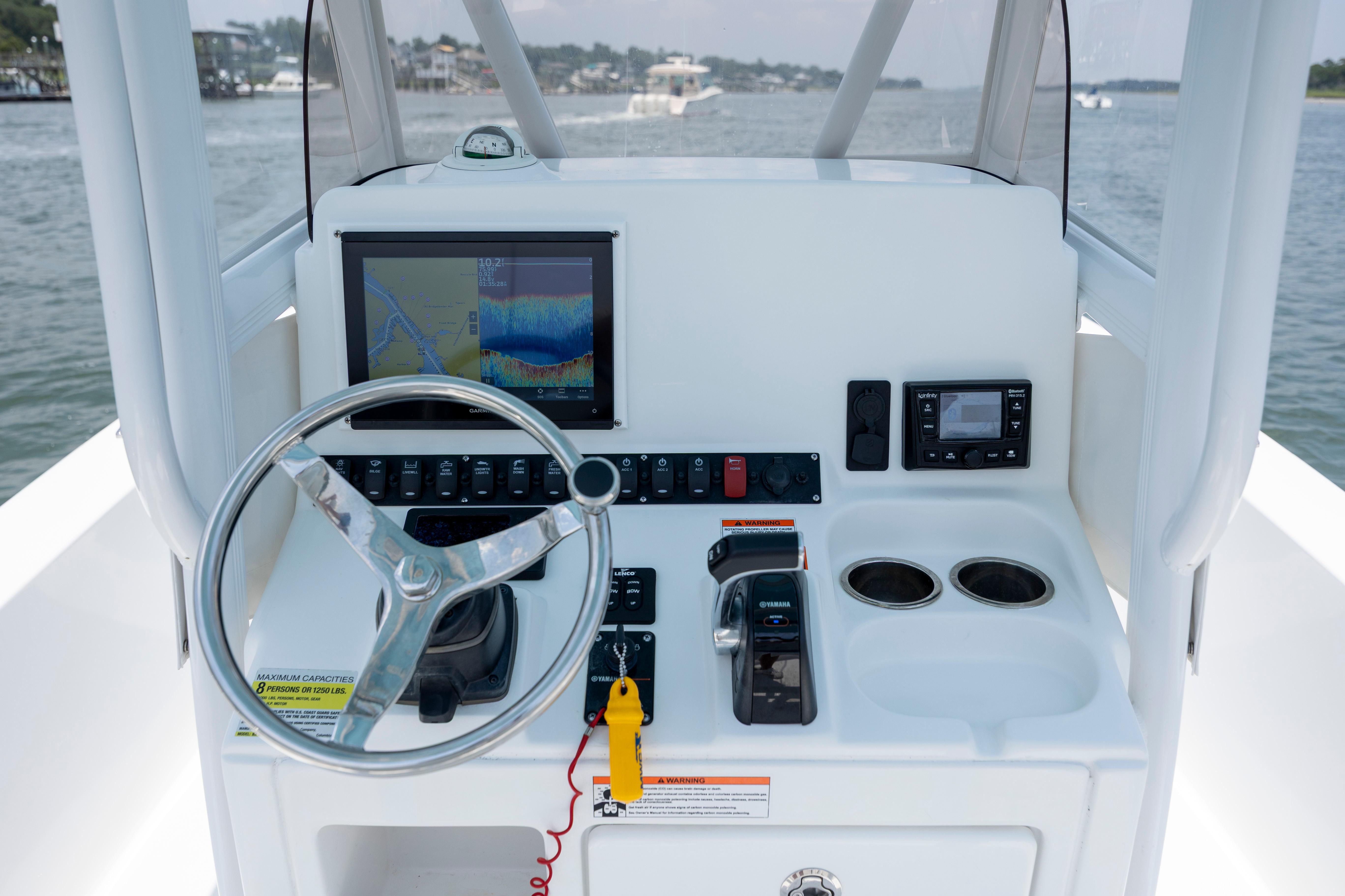 Slide: The Image of 2016 Sea Hunt BX 24 BR boat console with steering wheel, navigation display, and controls. - 20