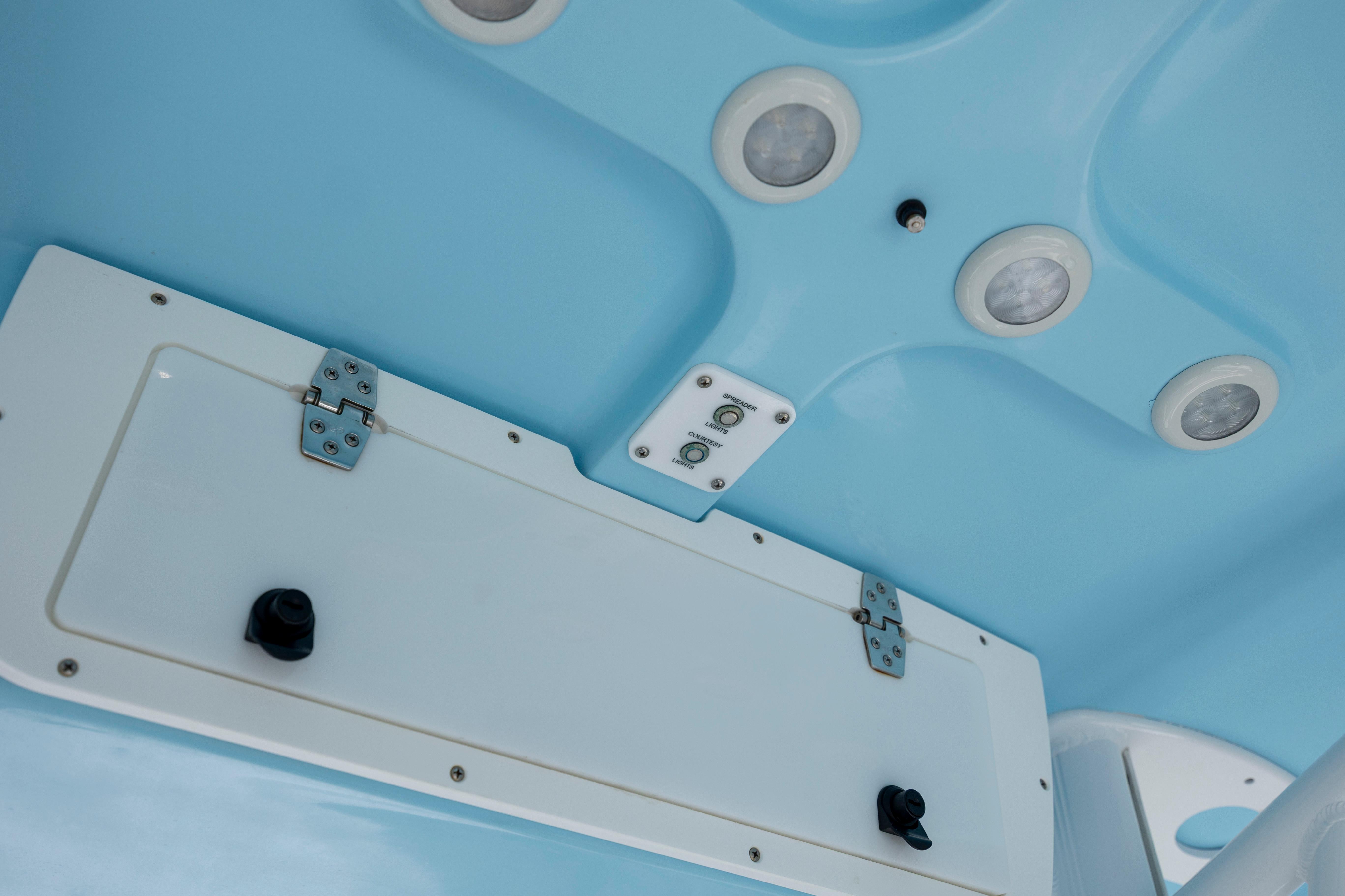 Slide: The Image of 2016 Sea Hunt BX 24 BR boat interior ceiling with lights and storage compartment. - 21