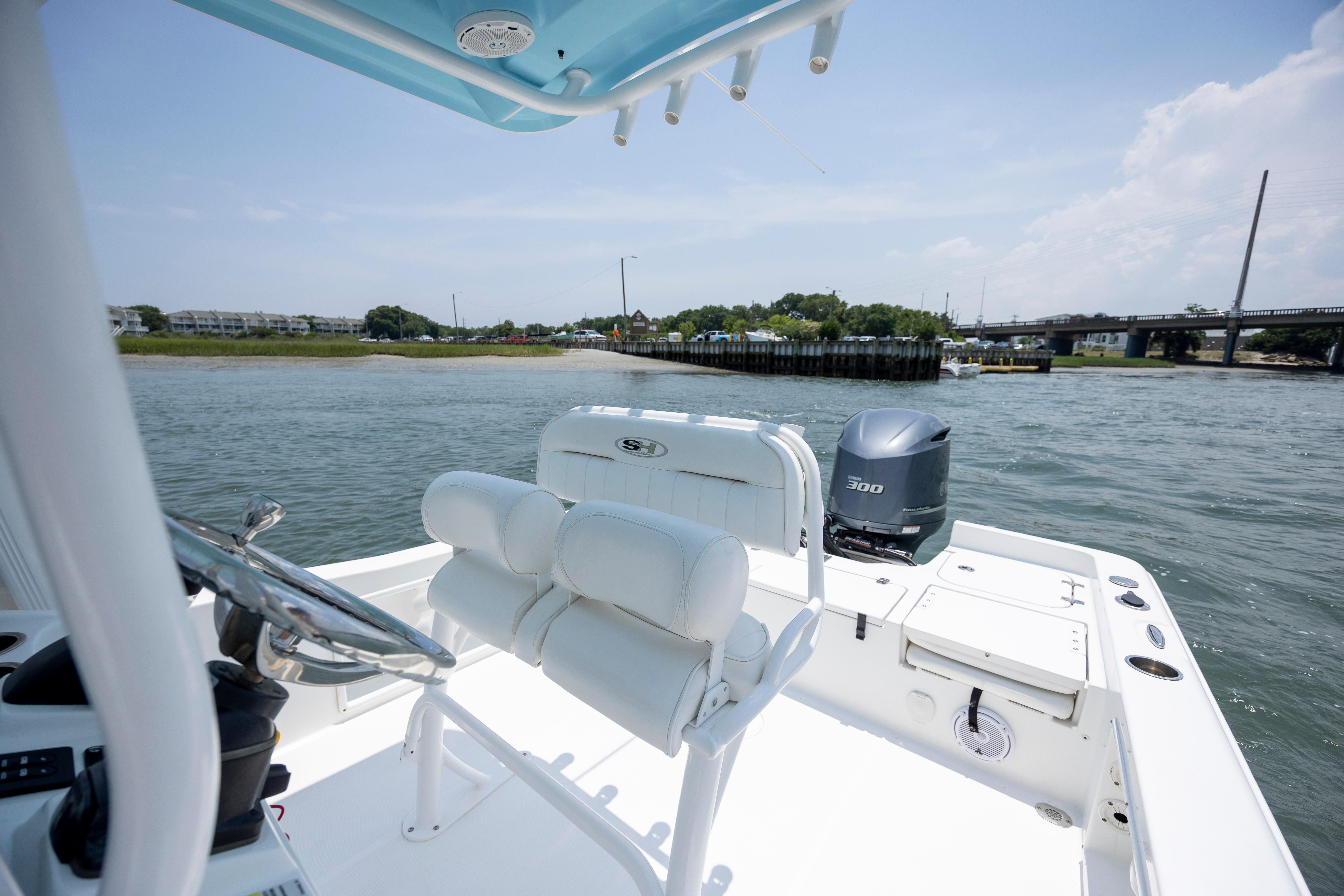 Slide: The Image of 2016 Sea Hunt BX 24 BR boat on water, featuring helm and seating area. - 22