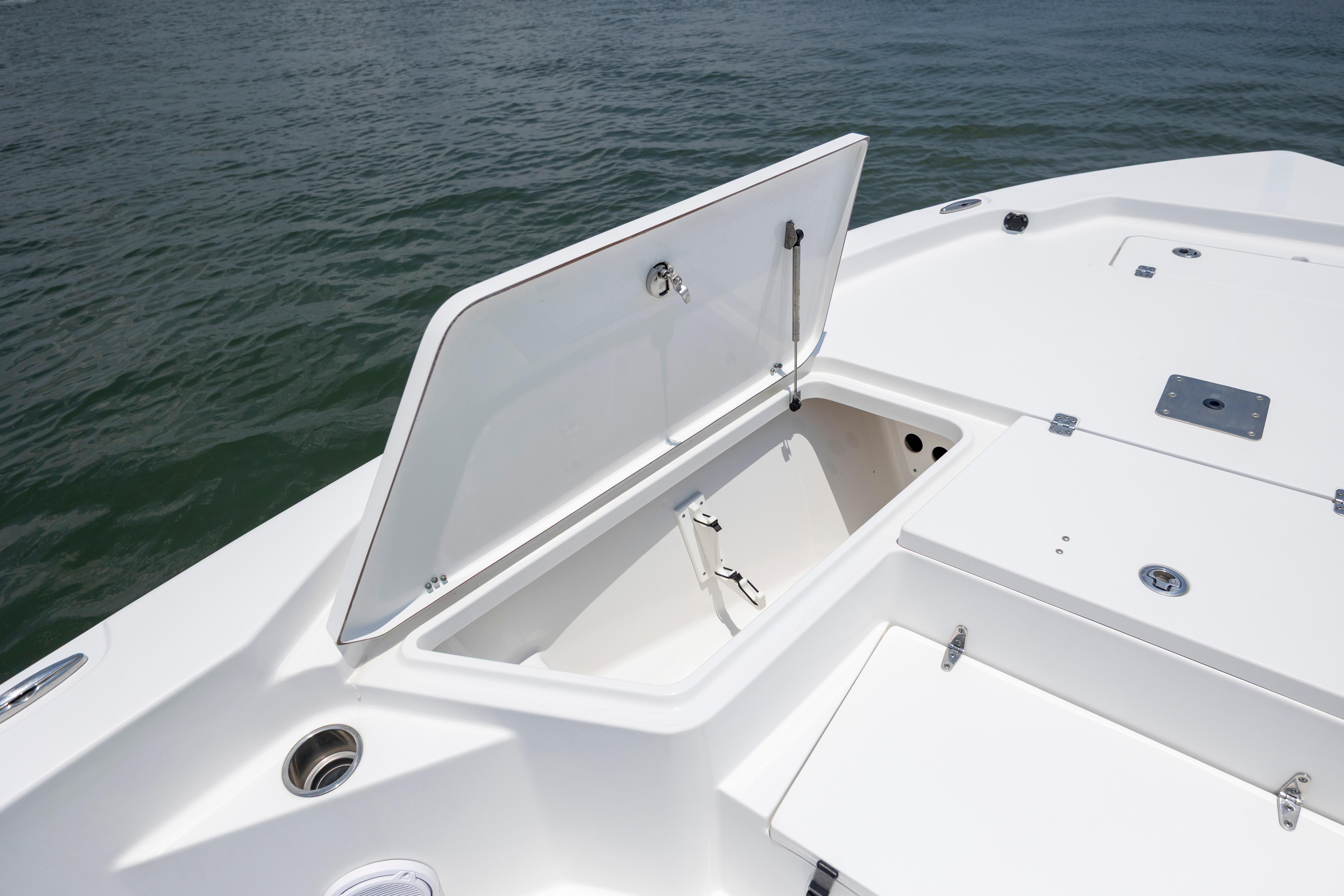 Slide: The Image of 2016 Sea Hunt BX 24 BR boat with open storage compartment on calm water. - 27
