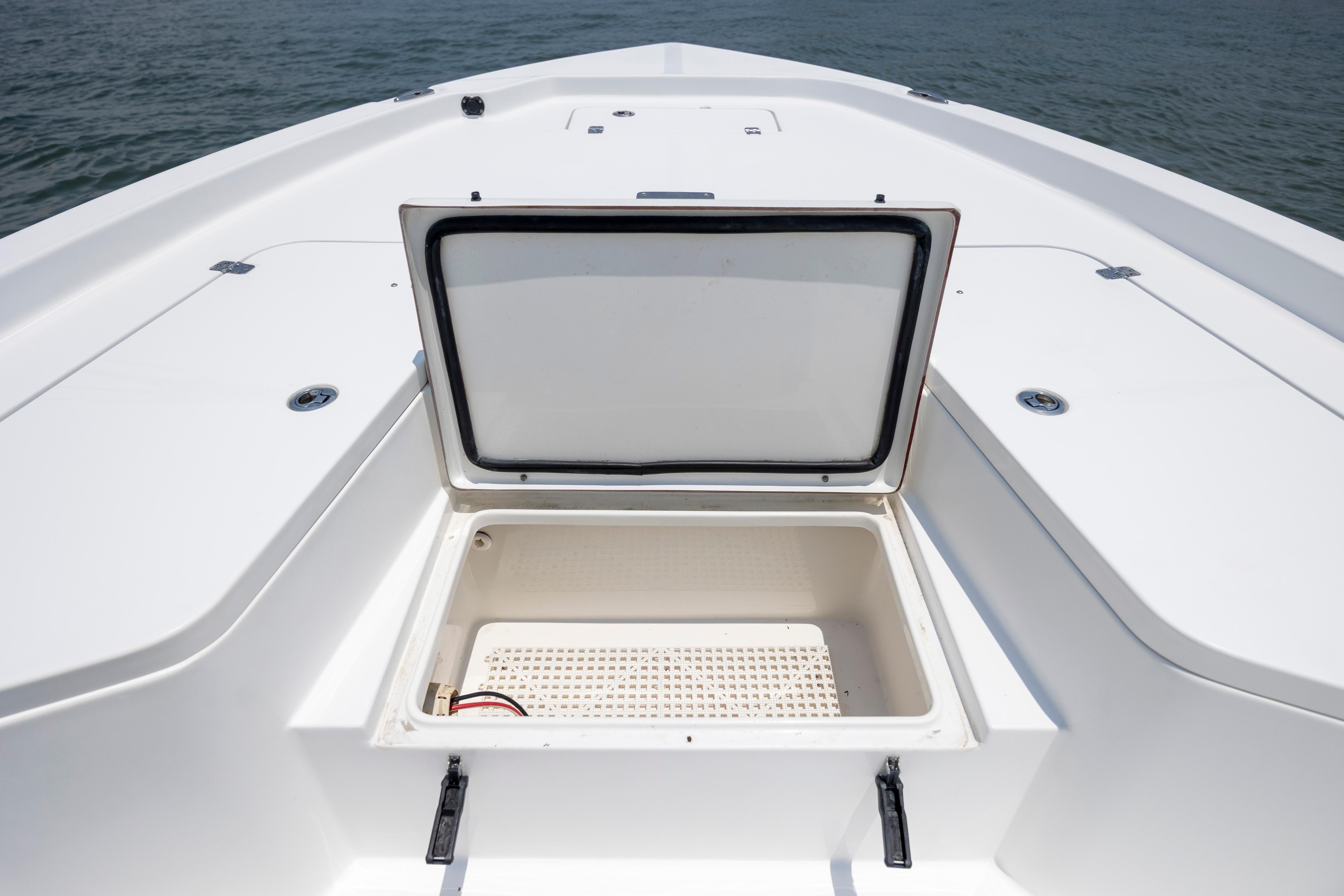 Slide: The Image of 2016 Sea Hunt BX 24 BR boat with open storage compartment on deck. - 28