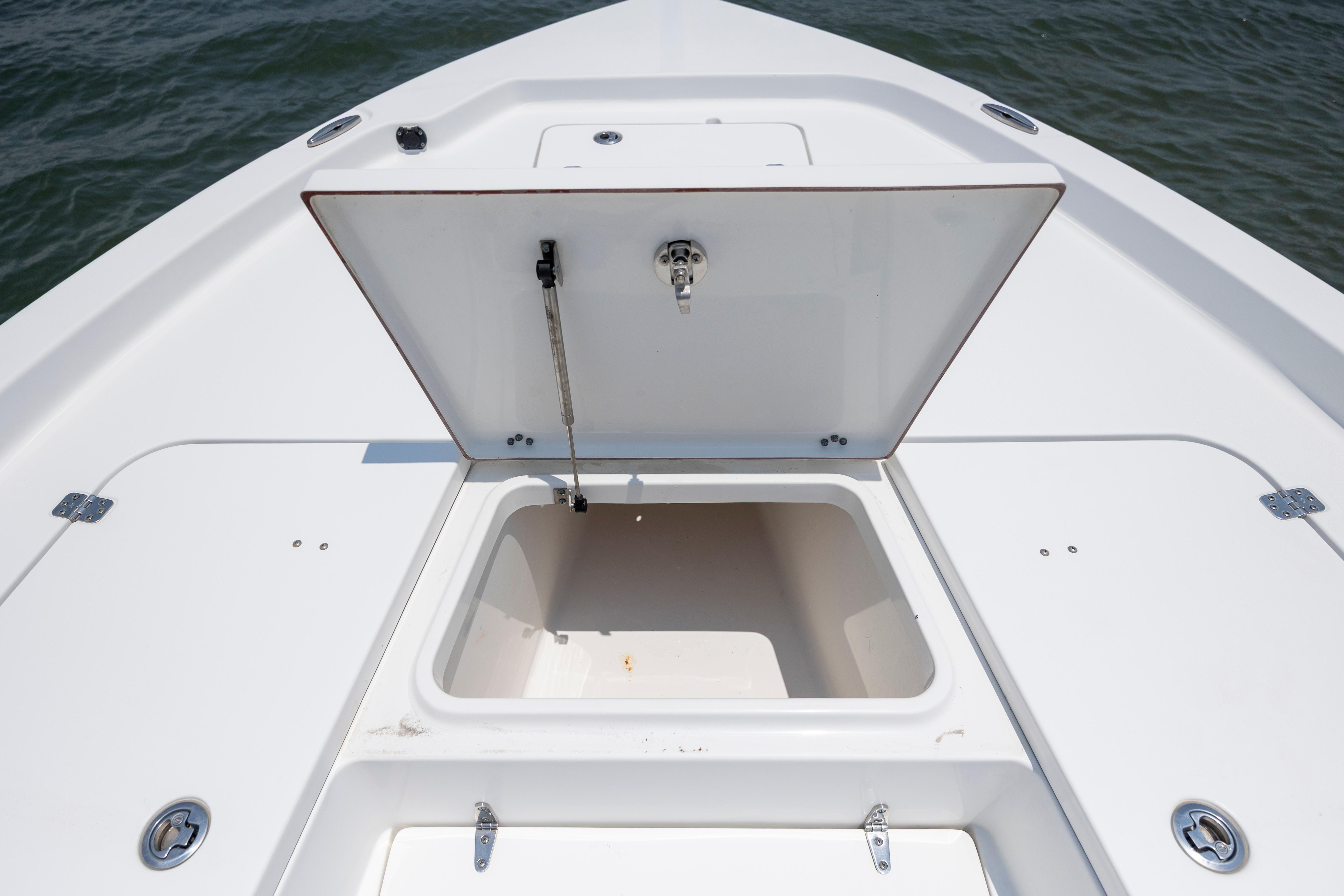 Slide: The Image of 2016 Sea Hunt BX 24 BR boat with open storage compartment on deck. - 29