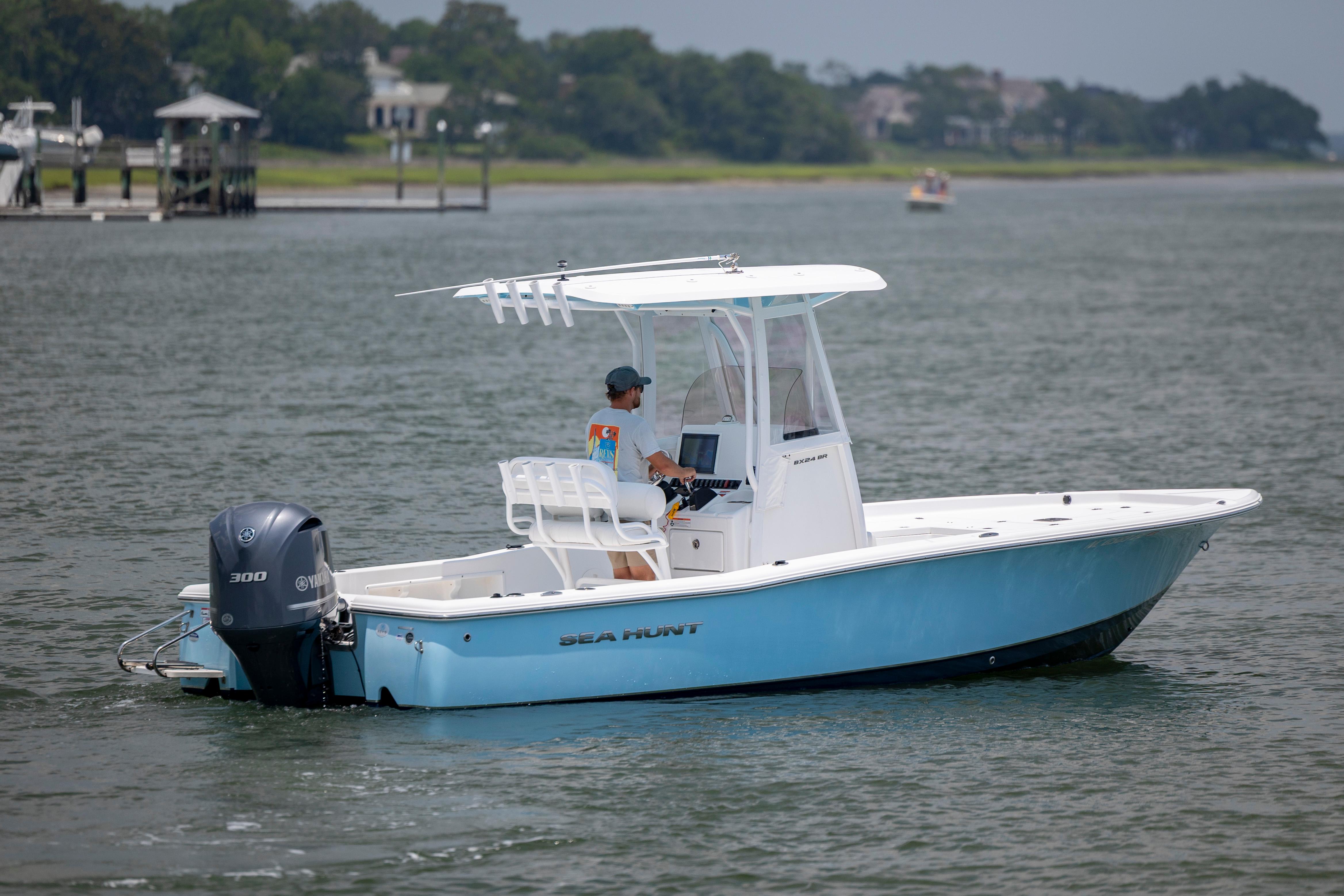 Slide: The Image of 2016 Sea Hunt BX 24 BR boat on calm water with Yamaha engine. - 3