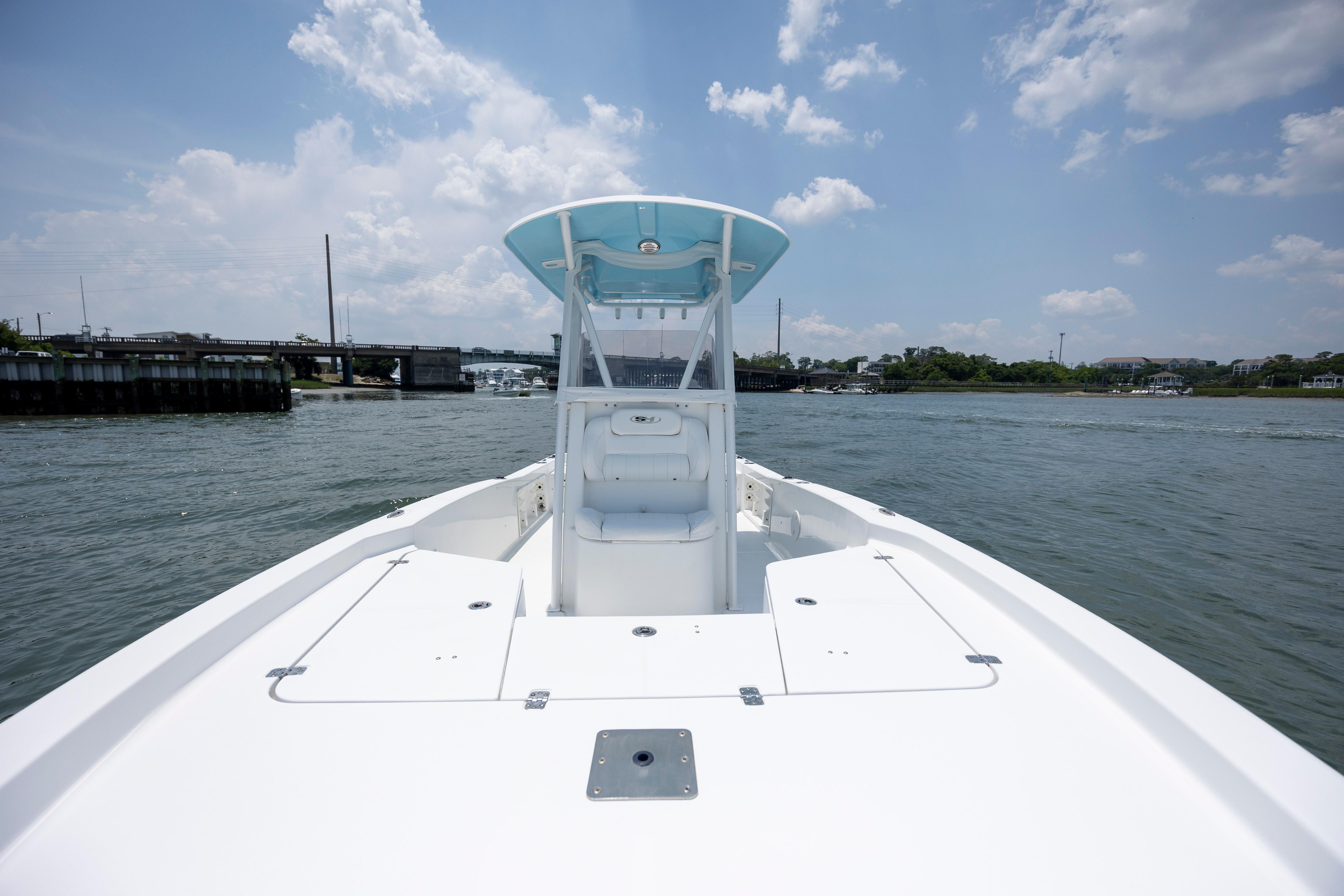 Slide: The Image of 2016 Sea Hunt BX 24 BR boat on calm water under a partly cloudy sky. - 30