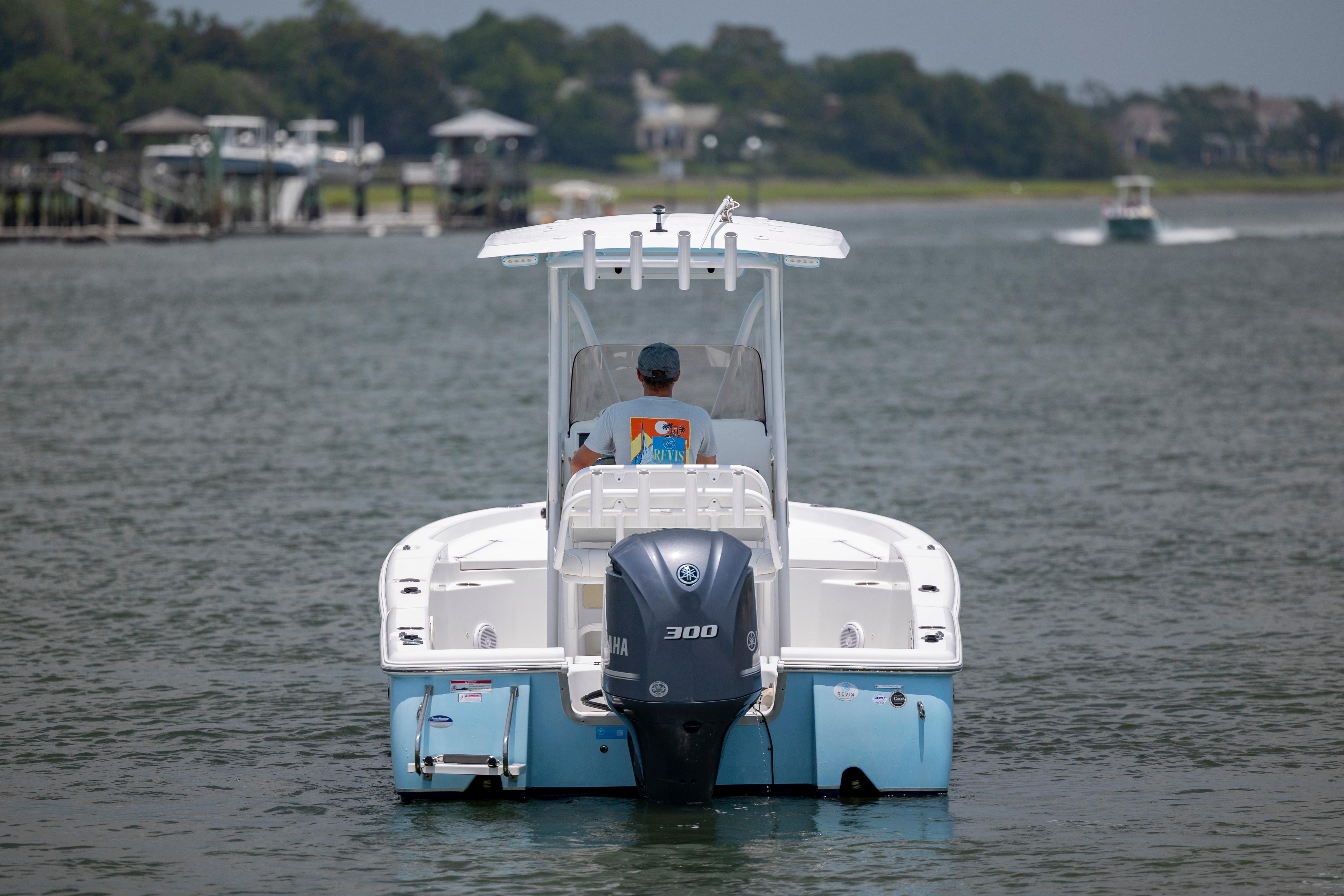 Slide: The Image of 2016 Sea Hunt BX 24 BR boat cruising on a calm waterway. - 4