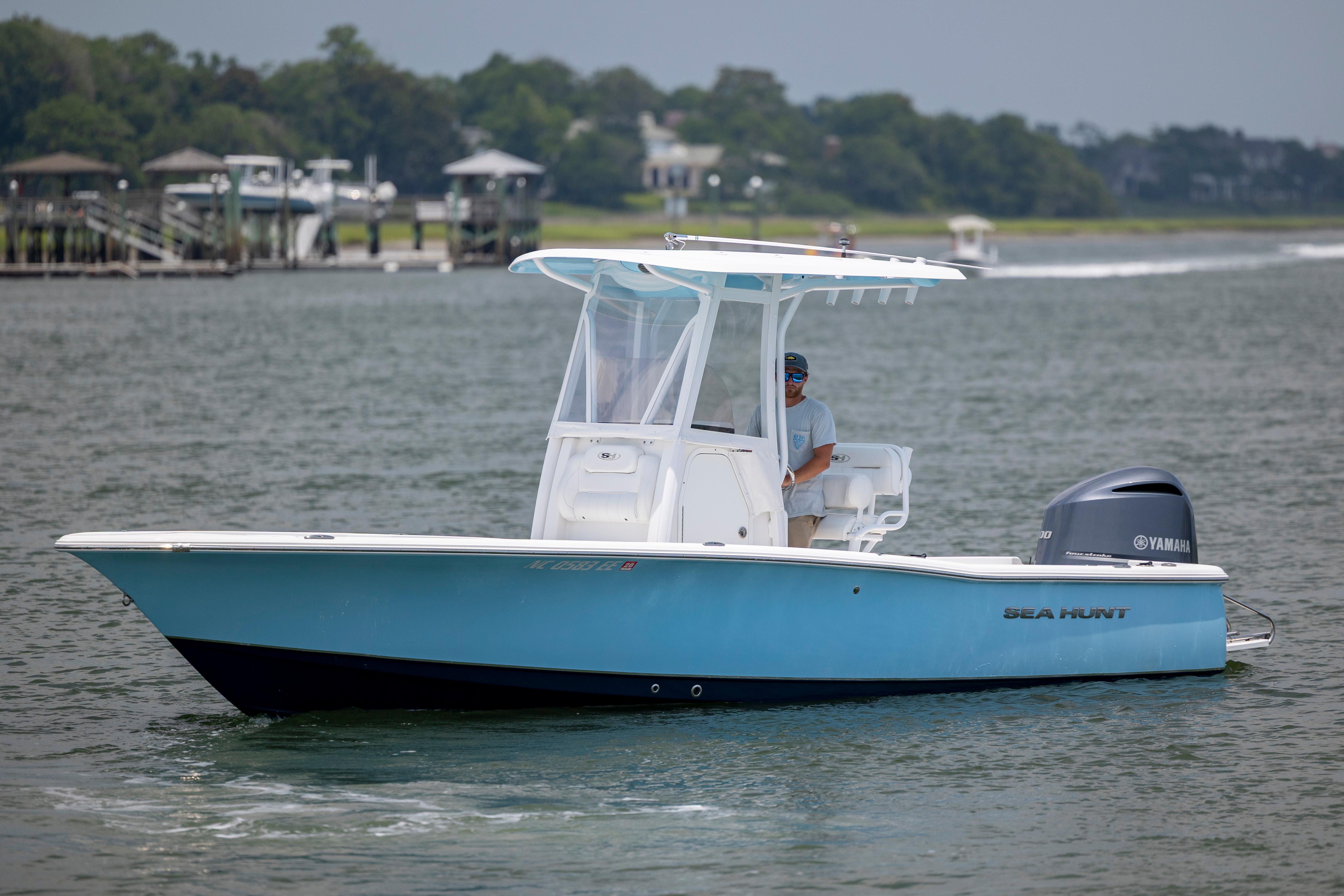 Slide: The Image of 2016 Sea Hunt BX 24 BR boat cruising on a calm waterway. - 7